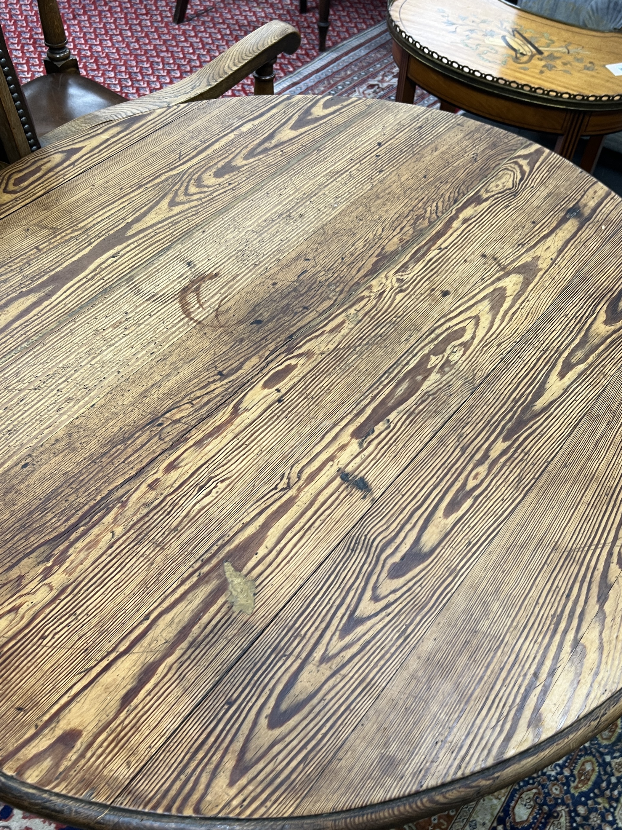 A 19th century French oval oak and pine tilt top folding table, width 90cm, depth 100cm, height 72cm